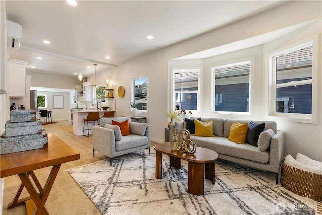 5310 46th Ave S, Seattle, WA 98118 - living room with light wood-style floors, recessed lighting, and a wall mounted AC