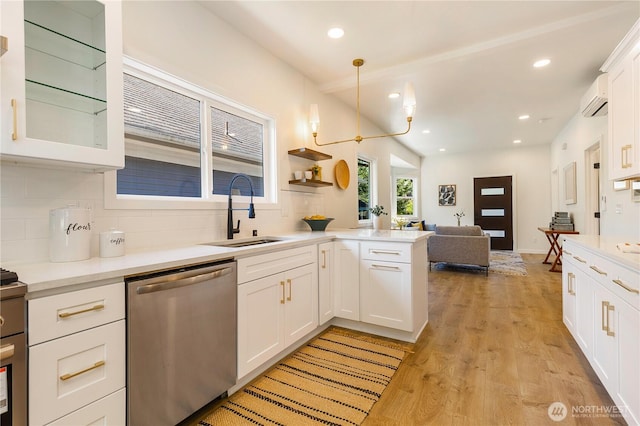 5310 46th Ave S, Seattle, WA 98118 - kitchen with dishwasher, decorative backsplash, white cabinetry, an AC wall unit, and light countertops