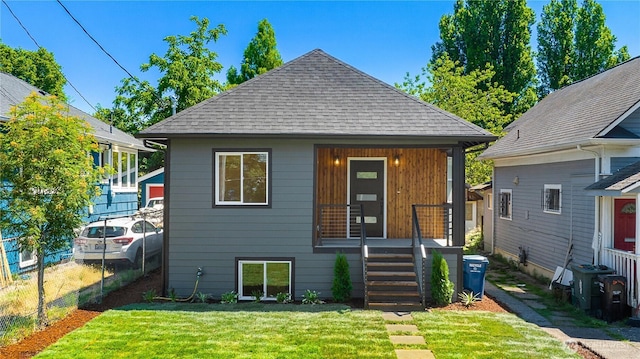 5310 46th Ave S, Seattle, WA 98118 - rear view of house with a shingled roof and a porch