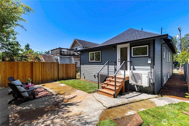 5310 46th Ave S, Seattle, WA 98118 - rear view of house with roof with shingles and a patio area