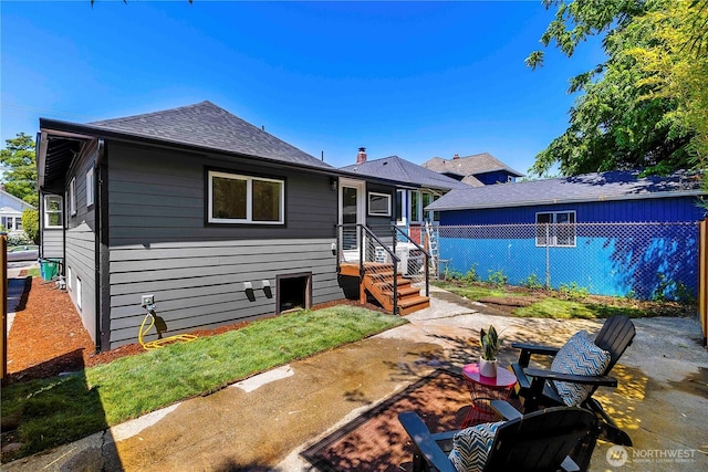5310 46th Ave S, Seattle, WA 98118 - rear view of property with a patio and a shingled roof
