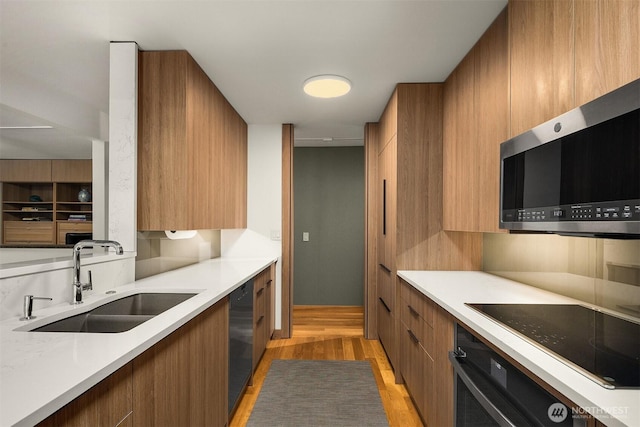 3650 26th Pl W Unit 202A, Seattle, WA 98199 - kitchen with modern cabinets, brown cabinets, and light wood-type flooring