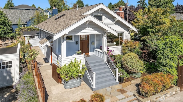 5817 28th Ave NW, Seattle, WA 98107 - bungalow-style house with a chimney, a shingled roof, and covered porch