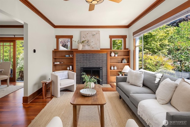 5817 28th Ave NW, Seattle, WA 98107 - living room with wood finished floors, crown molding, a ceiling fan, and a tile fireplace