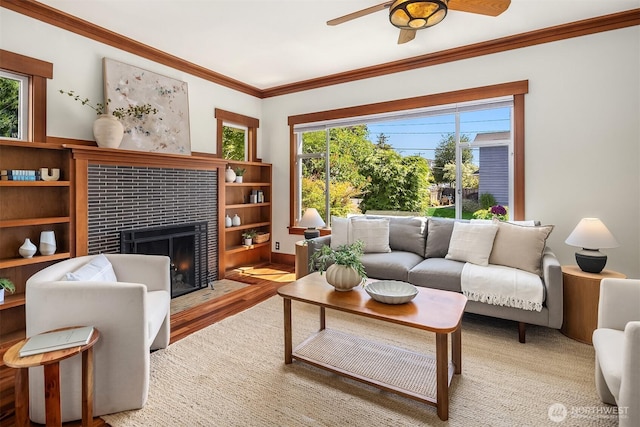 5817 28th Ave NW, Seattle, WA 98107 - living room with a fireplace, crown molding, ceiling fan, healthy amount of natural light, and wood finished floors