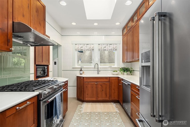 5817 28th Ave NW, Seattle, WA 98107 - kitchen with appliances with stainless steel finishes, extractor fan, light tile patterned floors, light countertops, and recessed lighting