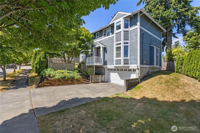 3055 49th Ave SW, Seattle, WA 98116 - view of front of home with concrete driveway, a front lawn, a garage, and stairway