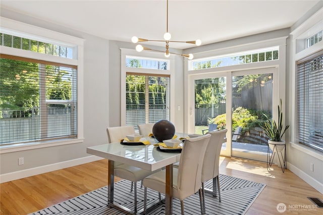 3055 49th Ave SW, Seattle, WA 98116 - dining room with light wood finished floors and a chandelier