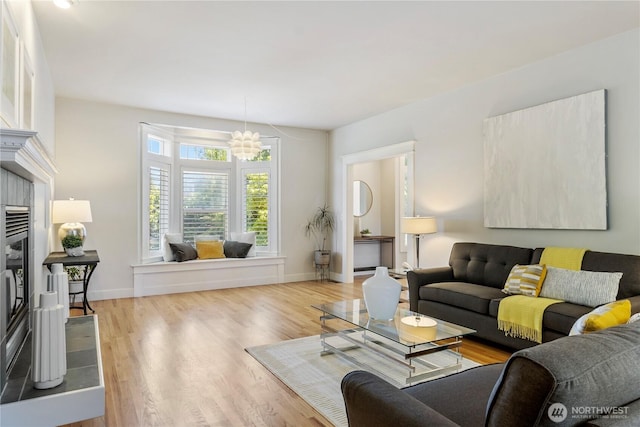 3055 49th Ave SW, Seattle, WA 98116 - living area with wood finished floors, a chandelier, and a fireplace