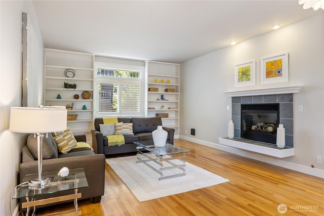 3055 49th Ave SW, Seattle, WA 98116 - living room with light wood-style flooring, a fireplace, and recessed lighting