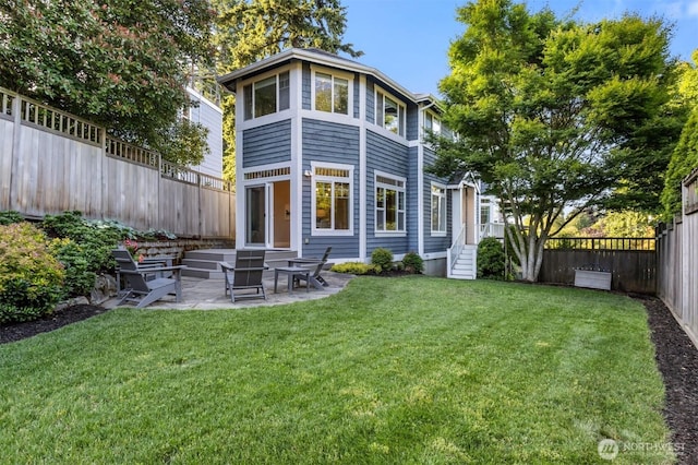 3055 49th Ave SW, Seattle, WA 98116 - rear view of house featuring a fenced backyard and a patio