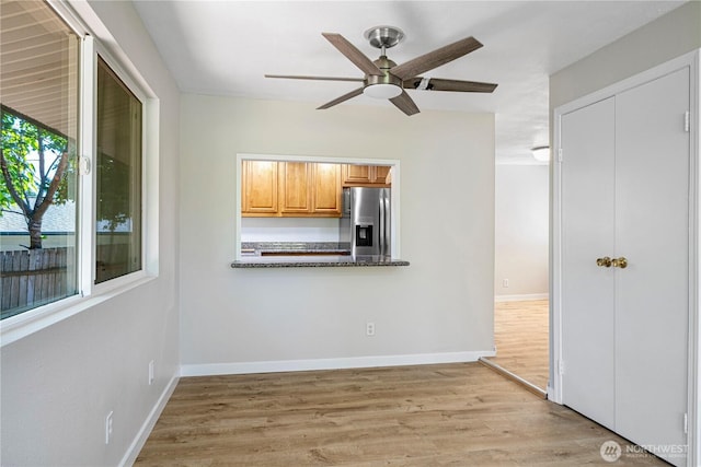 12621 SE 166th St, Renton, WA 98058 - kitchen with stainless steel refrigerator with ice dispenser, a ceiling fan, light wood-type flooring, and dark countertops