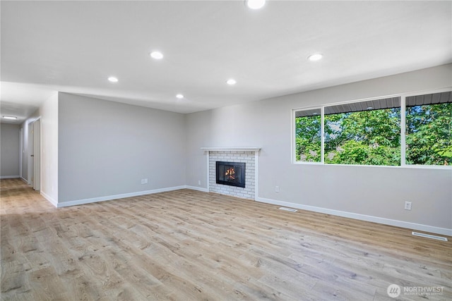 12621 SE 166th St, Renton, WA 98058 - unfurnished living room featuring recessed lighting, light wood-style flooring, and a fireplace