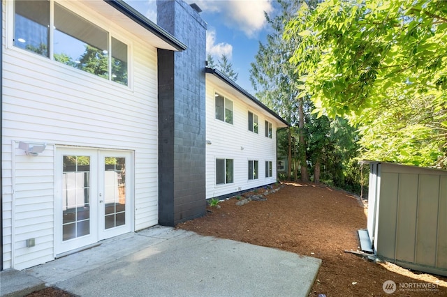 12621 SE 166th St, Renton, WA 98058 - rear view of house featuring a patio, french doors, and concrete block siding