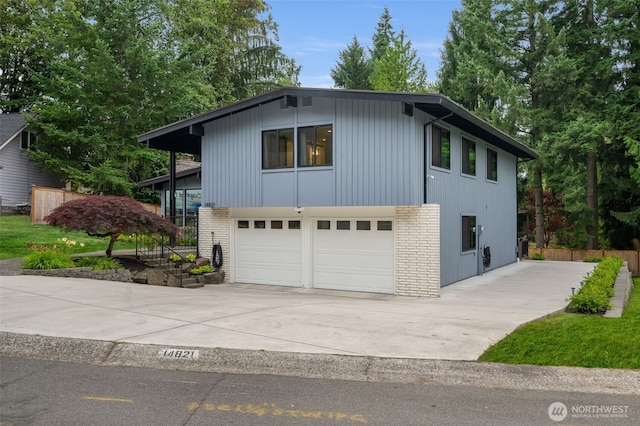 14821 117th Pl NE, Kirkland, WA 98034 - view of front of house featuring an attached garage, brick siding, and driveway