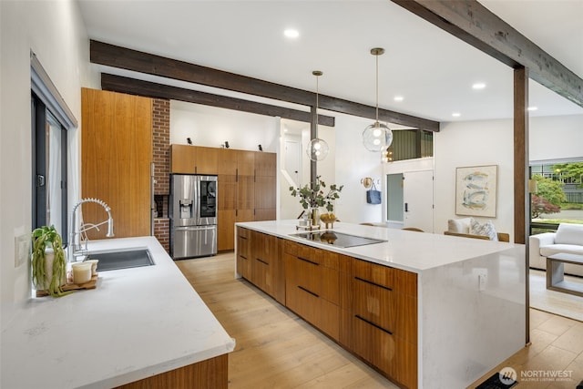 14821 117th Pl NE, Kirkland, WA 98034 - kitchen featuring stainless steel fridge, modern cabinets, beam ceiling, black electric cooktop, and brown cabinetry