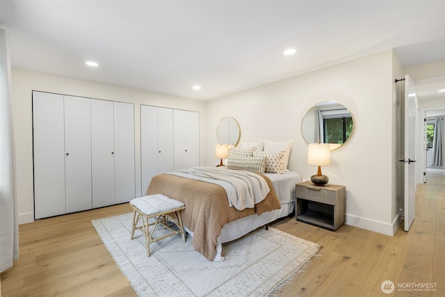 14821 117th Pl NE, Kirkland, WA 98034 - bedroom featuring light wood-style floors, two closets, and recessed lighting