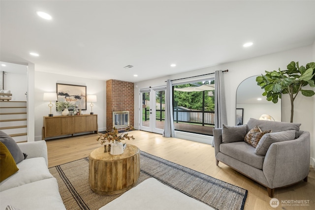 14821 117th Pl NE, Kirkland, WA 98034 - living room with light wood-style flooring, stairway, recessed lighting, and a fireplace