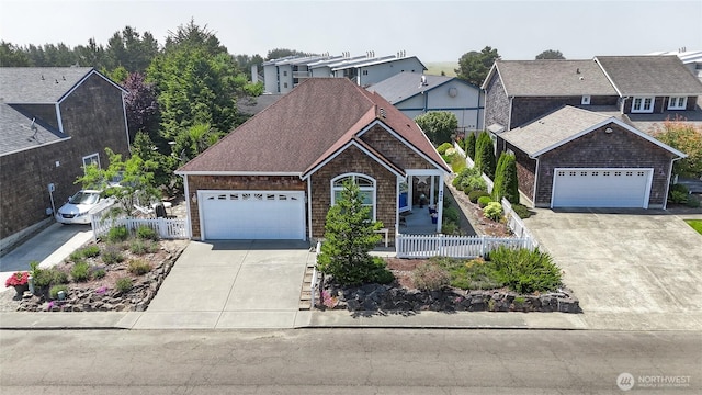2603 Sea Crest Ln, Long Beach, WA 98631 - view of front of property featuring concrete driveway, a fenced front yard, and an attached garage