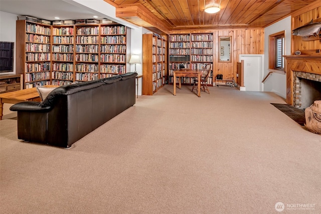 3006 43rd Ave W, Seattle, WA 98199 - living area featuring bookshelves, wooden ceiling, carpet flooring, wood walls, and built in shelves