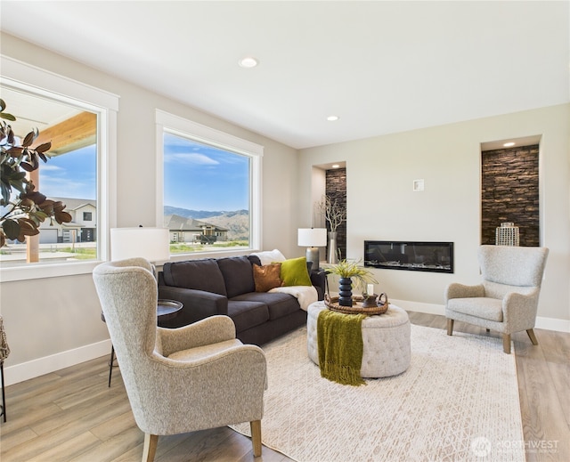 884 NE Tyler Pl E, Wenatchee, WA 98802 - living area with wood finished floors, recessed lighting, and a glass covered fireplace