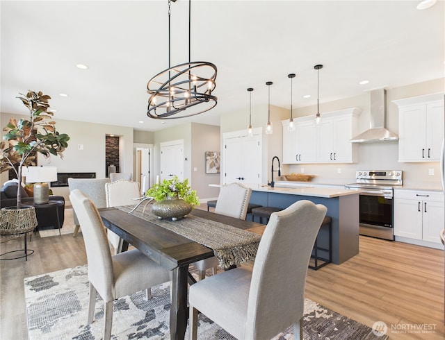 884 NE Tyler Pl E, Wenatchee, WA 98802 - dining space featuring light wood-type flooring, a chandelier, and recessed lighting