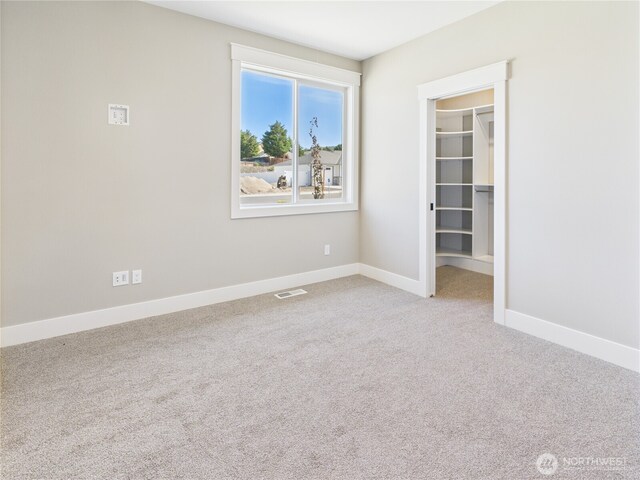 884 NE Tyler Pl E, Wenatchee, WA 98802 - unfurnished bedroom with a walk in closet and carpet flooring