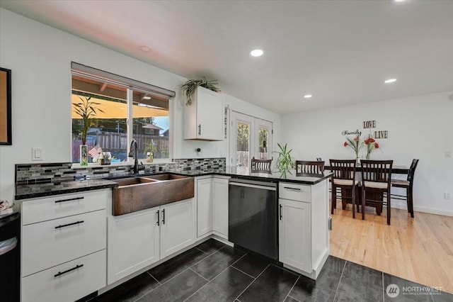 701 Mountain View Dr, Mount Vernon, WA 98273 - kitchen with stainless steel dishwasher, recessed lighting, white cabinets, a peninsula, and decorative backsplash