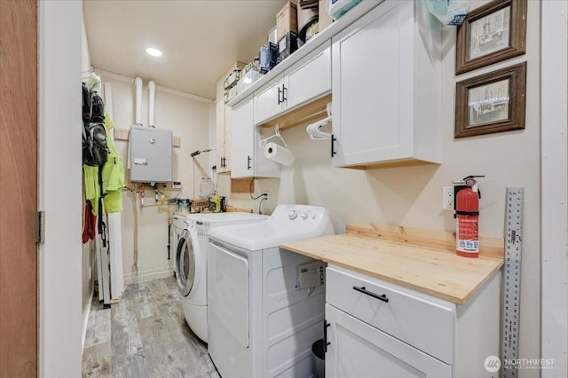 701 Mountain View Dr, Mount Vernon, WA 98273 - laundry area featuring washer and dryer, cabinet space, light wood-style floors, tankless water heater, and recessed lighting