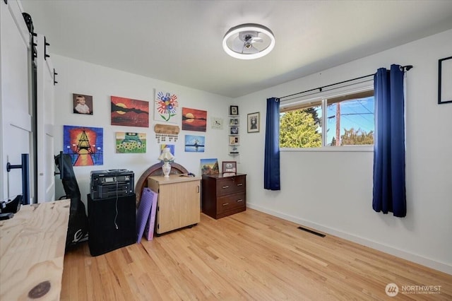 701 Mountain View Dr, Mount Vernon, WA 98273 - bedroom with light wood-style flooring, a barn door, and a desk