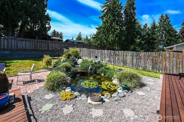 701 Mountain View Dr, Mount Vernon, WA 98273 - fenced backyard with a garden pond and a deck