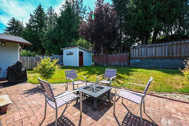 701 Mountain View Dr, Mount Vernon, WA 98273 - fenced backyard featuring a patio area, a shed, an outdoor fire pit, and a grill