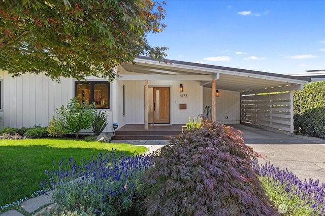 8733 21st Ave NW, Seattle, WA 98117 - view of front of house featuring an attached carport, driveway, a front yard, and covered porch