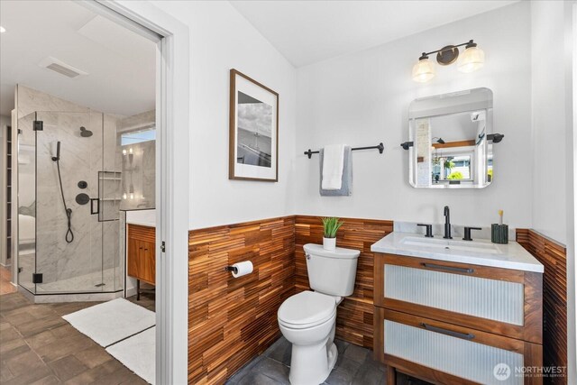 8733 21st Ave NW, Seattle, WA 98117 - full bathroom featuring vanity, a shower stall, and wainscoting