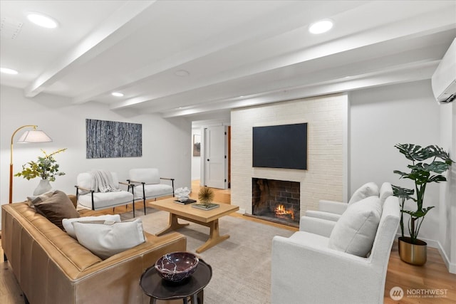 8733 21st Ave NW, Seattle, WA 98117 - living area with light wood-style flooring, a fireplace, recessed lighting, beam ceiling, and a wall mounted air conditioner