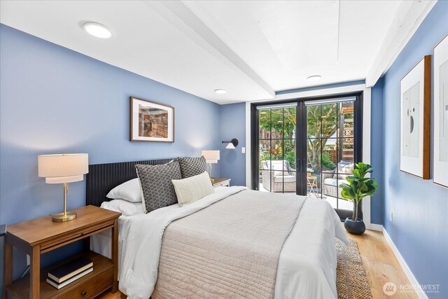8733 21st Ave NW, Seattle, WA 98117 - bedroom with wood finished floors, access to outside, and french doors