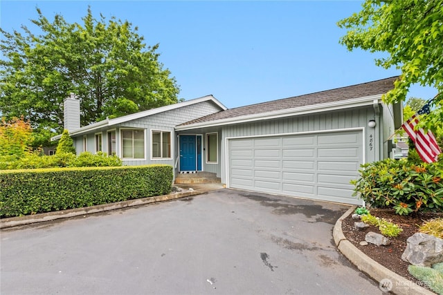 4867 N Village Ln, Bellingham, WA 98226 - single story home featuring a chimney, a garage, and asphalt driveway