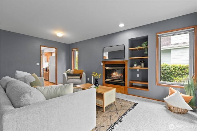 4867 N Village Ln, Bellingham, WA 98226 - living room with plenty of natural light, a glass covered fireplace, light carpet, and built in features