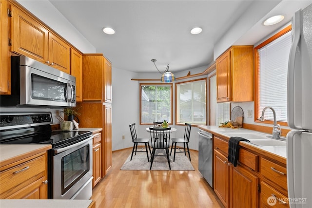 4867 N Village Ln, Bellingham, WA 98226 - kitchen with stainless steel appliances, light countertops, light wood finished floors, recessed lighting, and brown cabinets