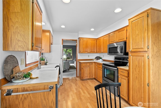 4867 N Village Ln, Bellingham, WA 98226 - kitchen featuring appliances with stainless steel finishes, light countertops, light wood-style floors, recessed lighting, and brown cabinets