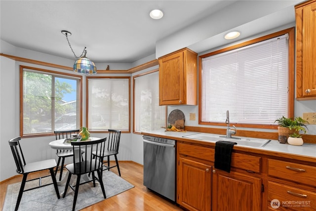 4867 N Village Ln, Bellingham, WA 98226 - kitchen featuring dishwasher, light countertops, light wood-style flooring, brown cabinetry, and recessed lighting