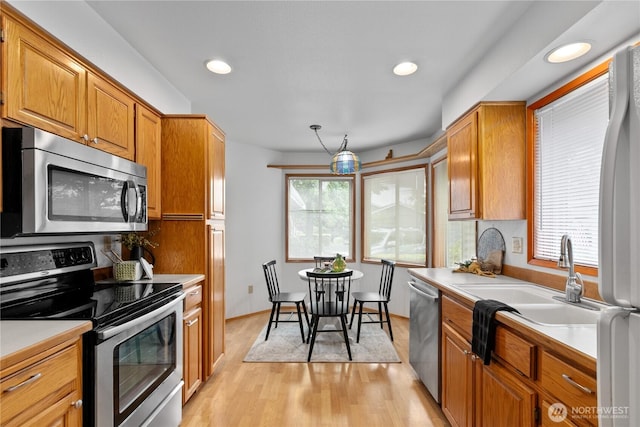 4867 N Village Ln, Bellingham, WA 98226 - kitchen with appliances with stainless steel finishes, light countertops, light wood-style floors, recessed lighting, and brown cabinets