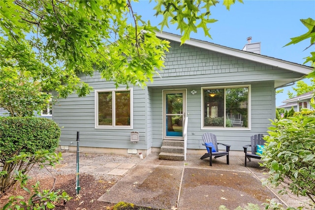 4867 N Village Ln, Bellingham, WA 98226 - rear view of property featuring a chimney and a patio area