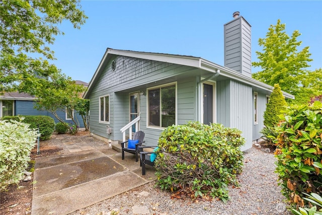 4867 N Village Ln, Bellingham, WA 98226 - view of home's exterior with a chimney and a patio