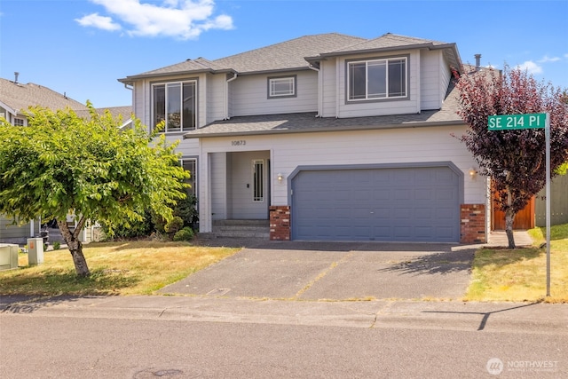 10873 SE 214th Pl, Kent, WA 98031 - traditional-style house featuring driveway, brick siding, a garage, and roof with shingles