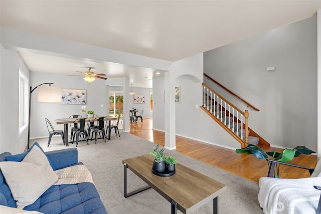 10873 SE 214th Pl, Kent, WA 98031 - living area with ceiling fan, stairs, and arched walkways
