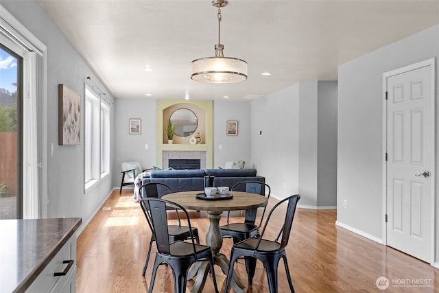 10873 SE 214th Pl, Kent, WA 98031 - dining room with healthy amount of natural light, light wood-type flooring, a fireplace, and recessed lighting