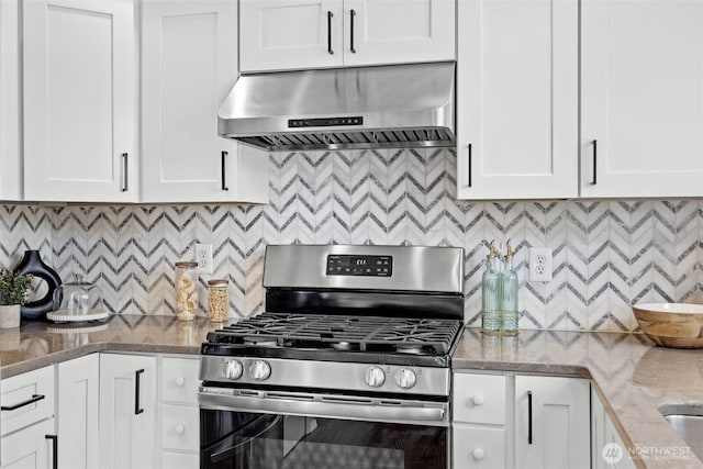 10873 SE 214th Pl, Kent, WA 98031 - kitchen featuring exhaust hood, gas stove, tasteful backsplash, and white cabinets