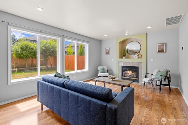 10873 SE 214th Pl, Kent, WA 98031 - living area with healthy amount of natural light, a tile fireplace, wood finished floors, and recessed lighting