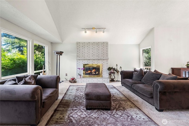 8113 S 121st St, Seattle, WA 98178 - living area with lofted ceiling, carpet flooring, healthy amount of natural light, a textured ceiling, and a brick fireplace